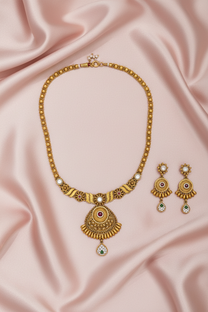 Antique Sunburst Necklace Set Flat Lay on Pink Satin