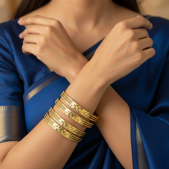Model Wearing Diamond-Cut Gold Bangles